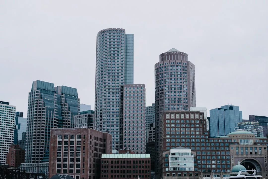 A city skyline with several modern high-rise buildings under an overcast sky, showcasing the potential of prime real estate.