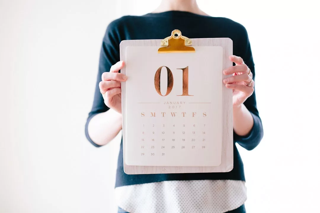A person holding a clipboard with a calendar showing January 2017, possibly planning real estate appointments or property viewings.