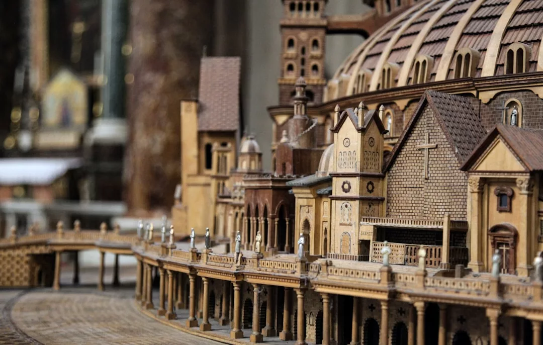 A detailed wooden architectural model of a historic building with domes, towers, arches, and intricate facade detailing, viewed from a side angle—perfect for showcasing classic Real Estate elegance.